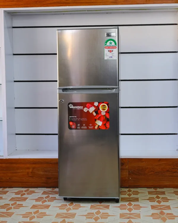 Ramtons Fridge 128Ltrs RF/177 128L double door refrigerator in Titan Steel finish – Features Direct Cool technology, wire shelves, 120W power rating, freezer door compartment, and CFC-free operation. Compact and energy-efficient design ideal for small kitchens and offices. Available now at TAEL Electronics and Appliances.