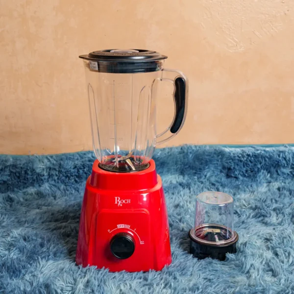 Roch RBL-112C 2-in-1 multifunctional standing blender with grinder attachment, featuring a 1.5L glass jug, 400W motor, stainless steel serrated blades, 2-speed and pulse function, mini-cup for grinding, and a vibrant red base. Durable, efficient, and ideal for smoothies, grinding, and everyday blending tasks. Available now at Tael Appliances.