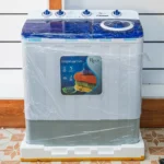Roch twin tub semi-automatic washing machine in white with blue lids at Tael Appliances.