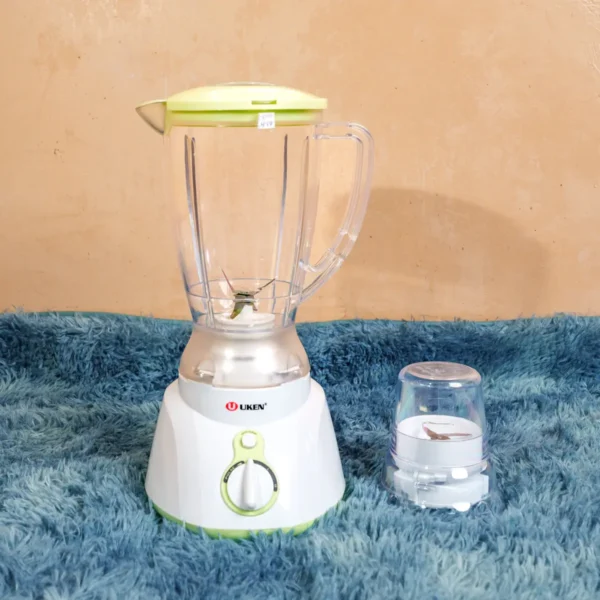 Uken Blender UB-1580 2-in-1 electric blender with a 1.5L glass jug and separate grinder attachment, featuring a stylish red base, available at Tael Appliances.