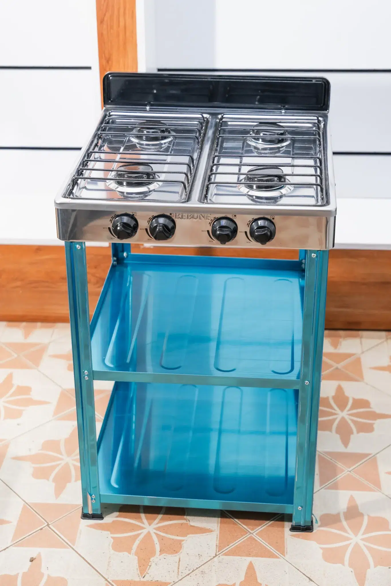 Rebune 4 Burner Gas Cooker 50x50 with Storage Shelves 2 Rebune 4 burner gas cooker on its stand, front view showing the two shelves at Tael Appliances.